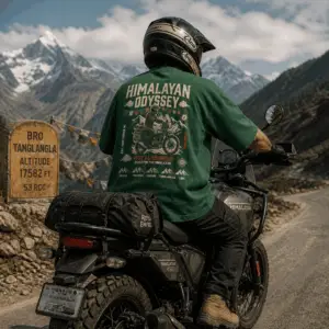 Back view of Royal Enfield Himalayan Odyssey bottle green oversized graphic t-shirt worn by a rider on a Himalayan 450 motorcycle at Tanglang La pass, 17,582 ft — ThreadEvoke India