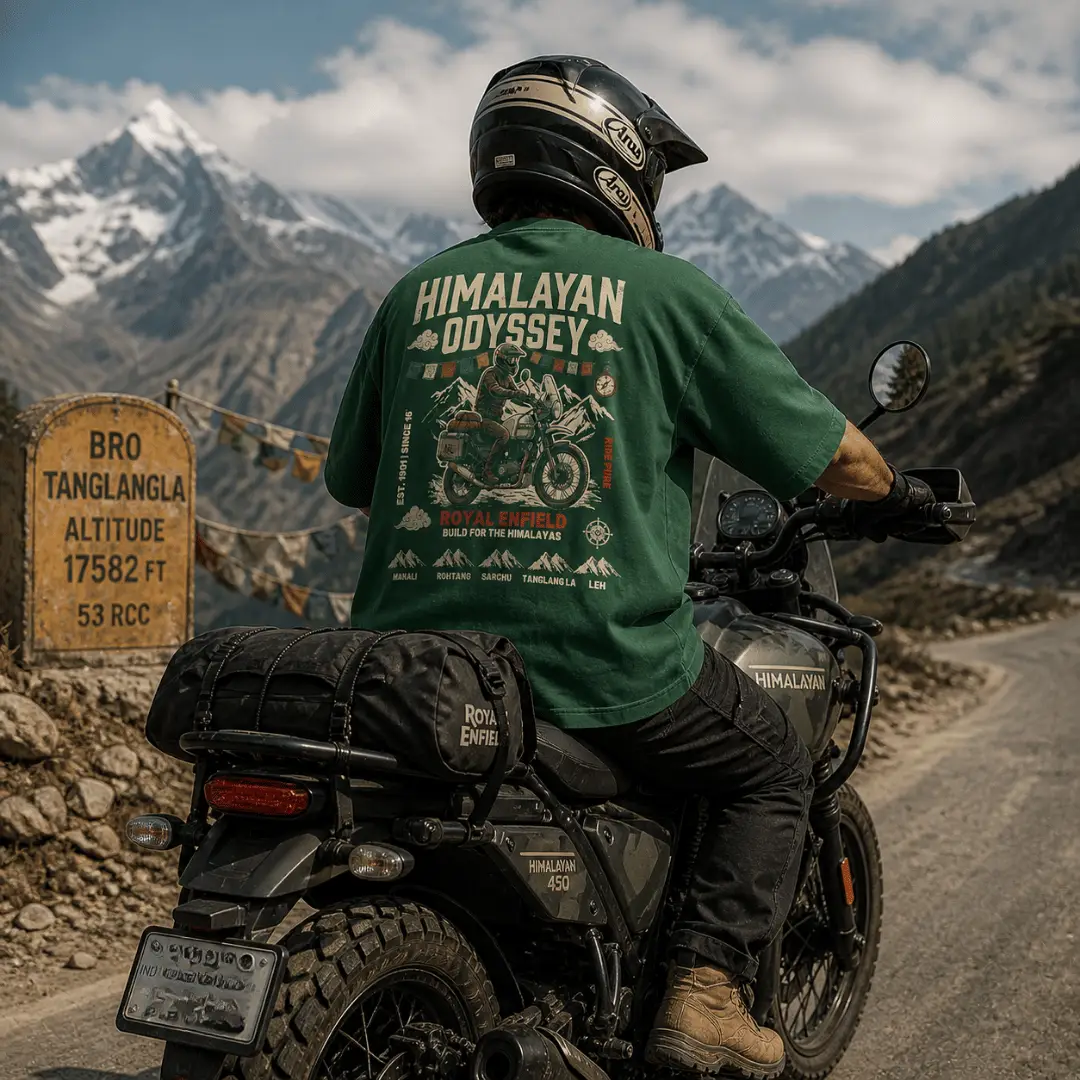 Back view of Royal Enfield Himalayan Odyssey bottle green oversized graphic t-shirt worn by a rider on a Himalayan 450 motorcycle at Tanglang La pass, 17,582 ft — ThreadEvoke India
