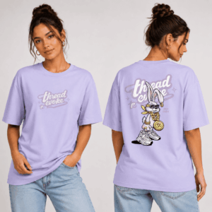 Front and back view of Thread Evoke women's lavender oversized t-shirt featuring tonal logo print on chest and bold bunny graphic on back, worn by a woman with blue jeans